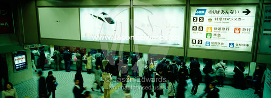 Commuters buy tickets for trains in the subway at Ikebukuro Station. Ikebukuro Station, Tokyo, Japan.