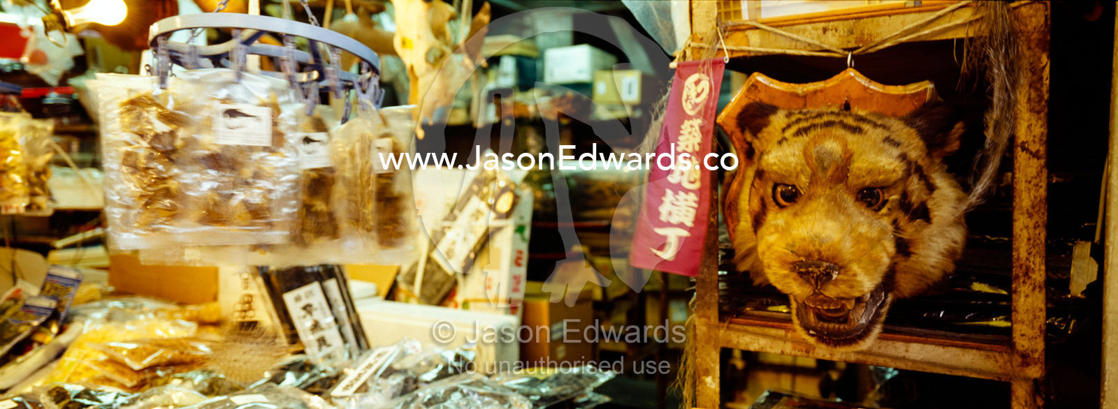 A traditional medicine shop selling an endangered Bengal tiger head. Tsukiji Fish Market, Tokyo, Japan.