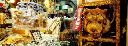 A traditional medicine shop selling an endangered Bengal tiger head. Tsukiji Fish Market, Tokyo, Japan.