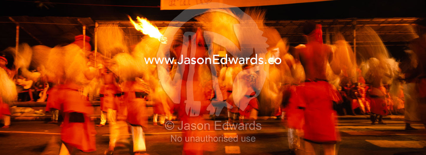 Kandyan dancers perform in a flurry of movement at the Esala Perahera. Kandy, Sri Lanka.