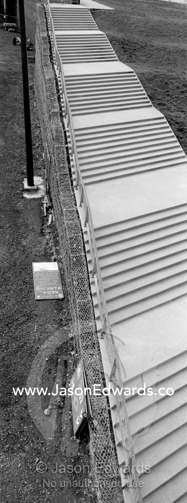 A cold and clinical set of concrete stairs rise to nowhere. Federation Square, Melbourne, Victoria, Australia.