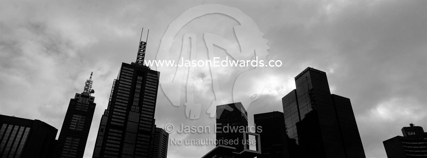The Melbourne city skyline rises into a cold, wintery, grey sky. Melbourne, Victoria, Australia.