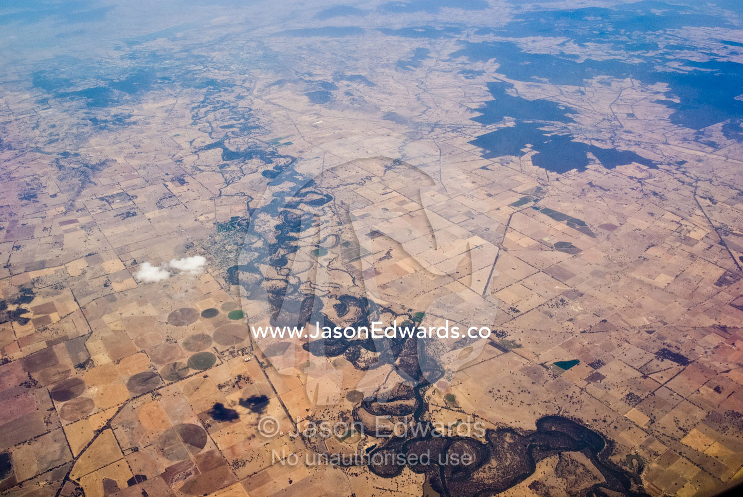 A river snakes its way through drought-stricken farmland in summer. Central Victoria, Australia.