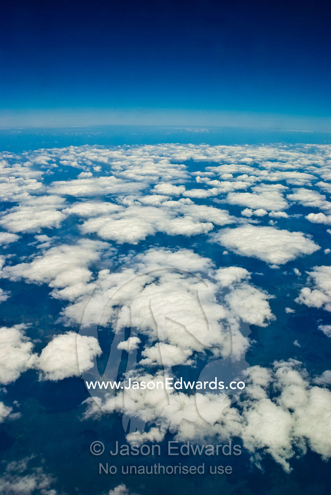 A fluffy cloud bank billows over the northern Queensland coastline. North Queensland, Australia.