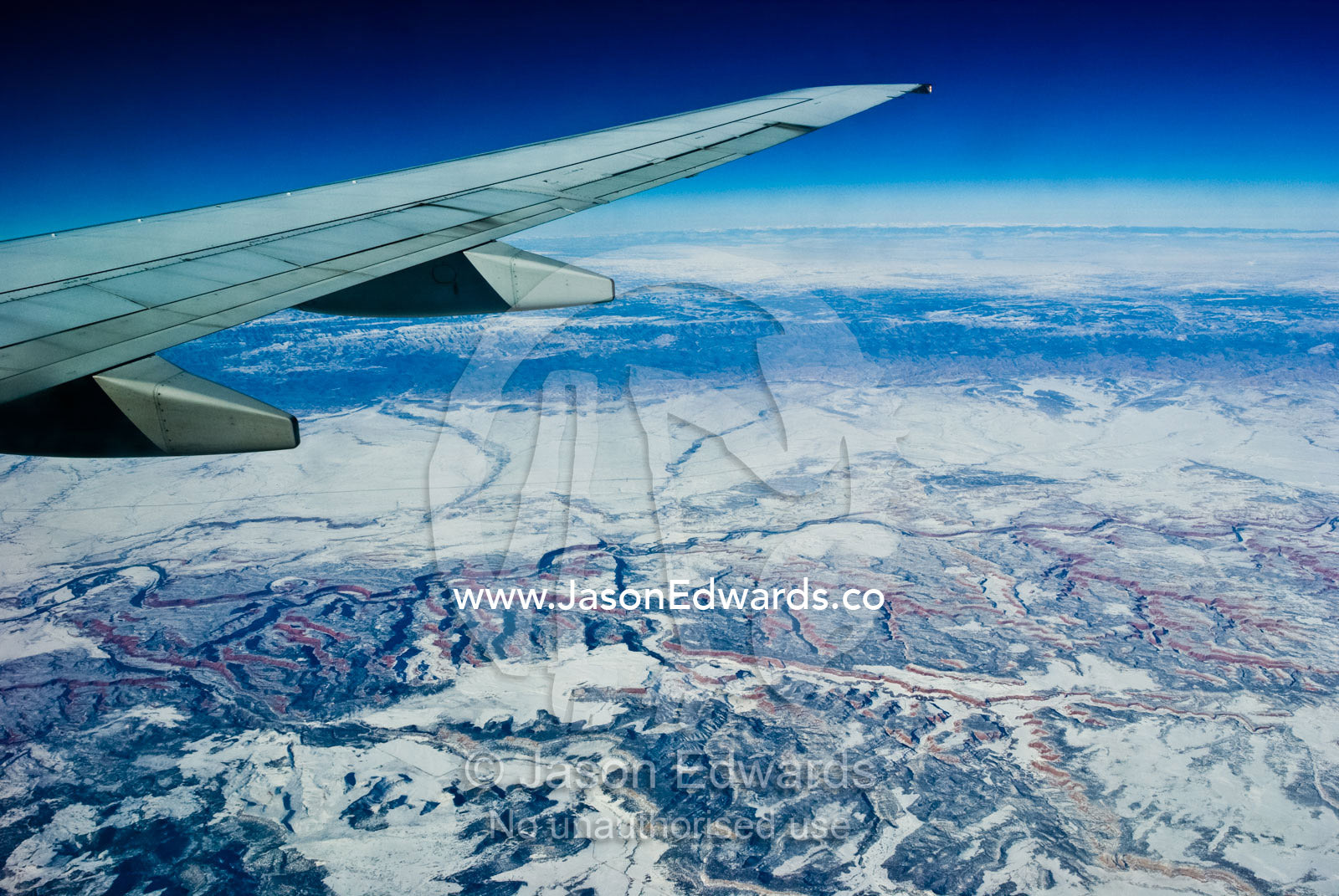 A high altitude view of rugged desert mountain ranges covered in snow. South West United States of America.
