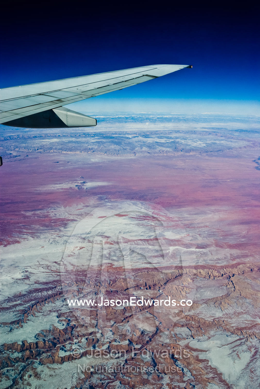 A high altitude view of rugged desert mountain ranges covered in snow. South West United States of America.