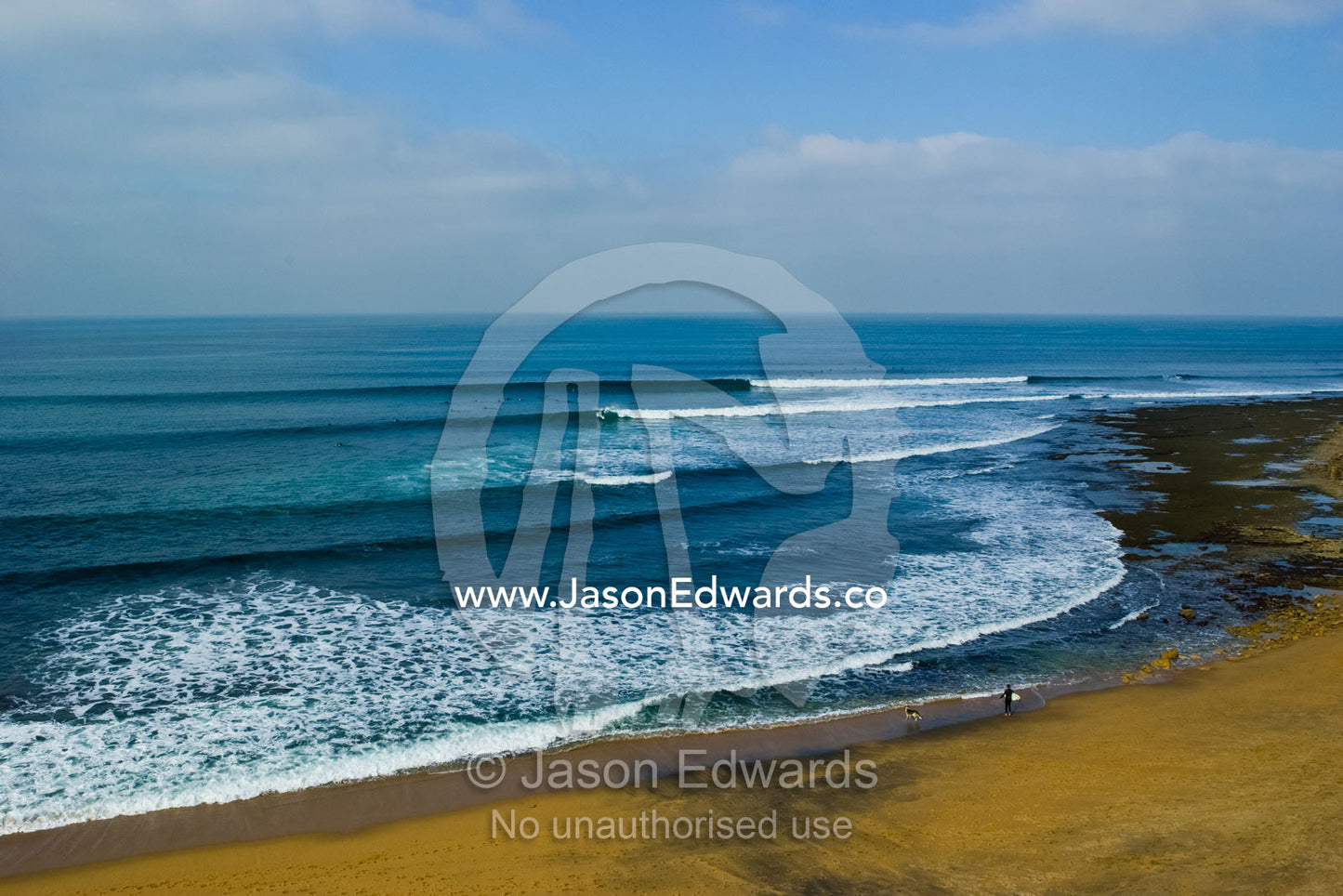 Lines of swell peel around the point at the surfing mecca Bells Beach. Bells Beach, Victoria, Australia.