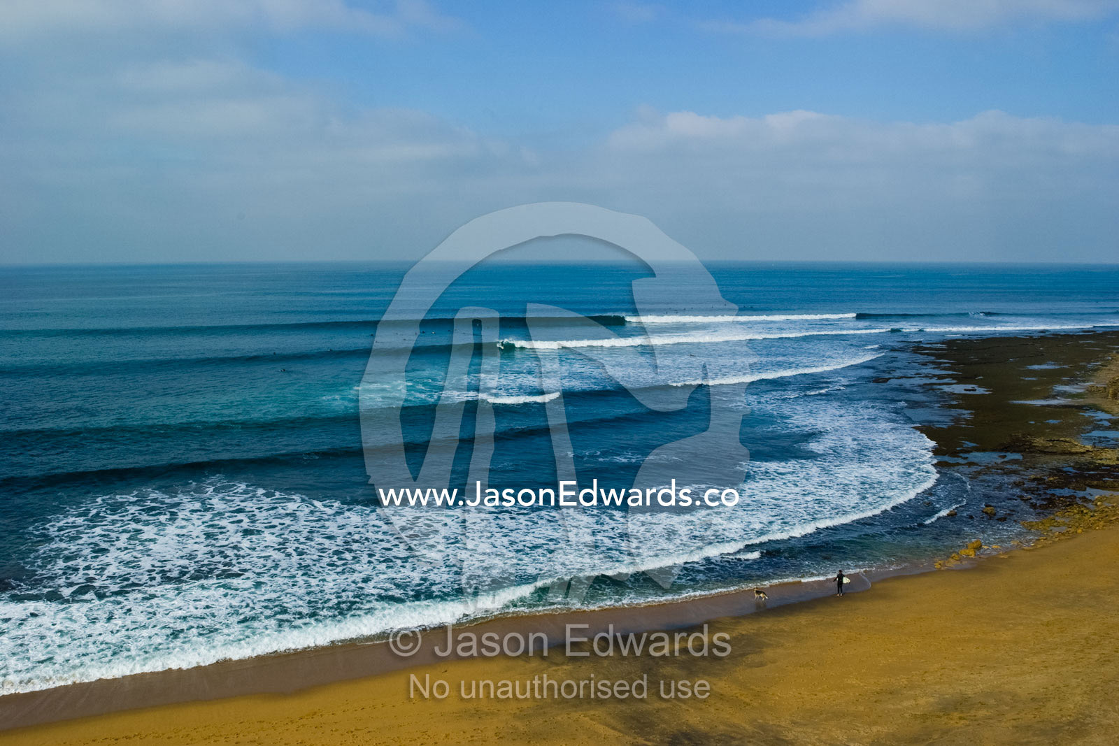 Lines of swell peel around the point at the surfing mecca Bells Beach. Bells Beach, Victoria, Australia.