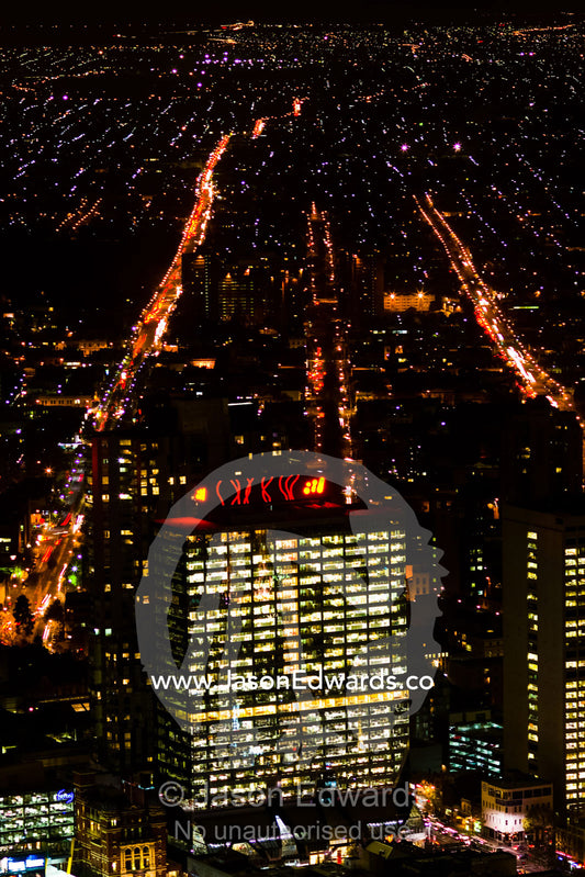 Energy hungry office towers illuminate the night sky in a major city. Melbourne, Victoria, Australia.