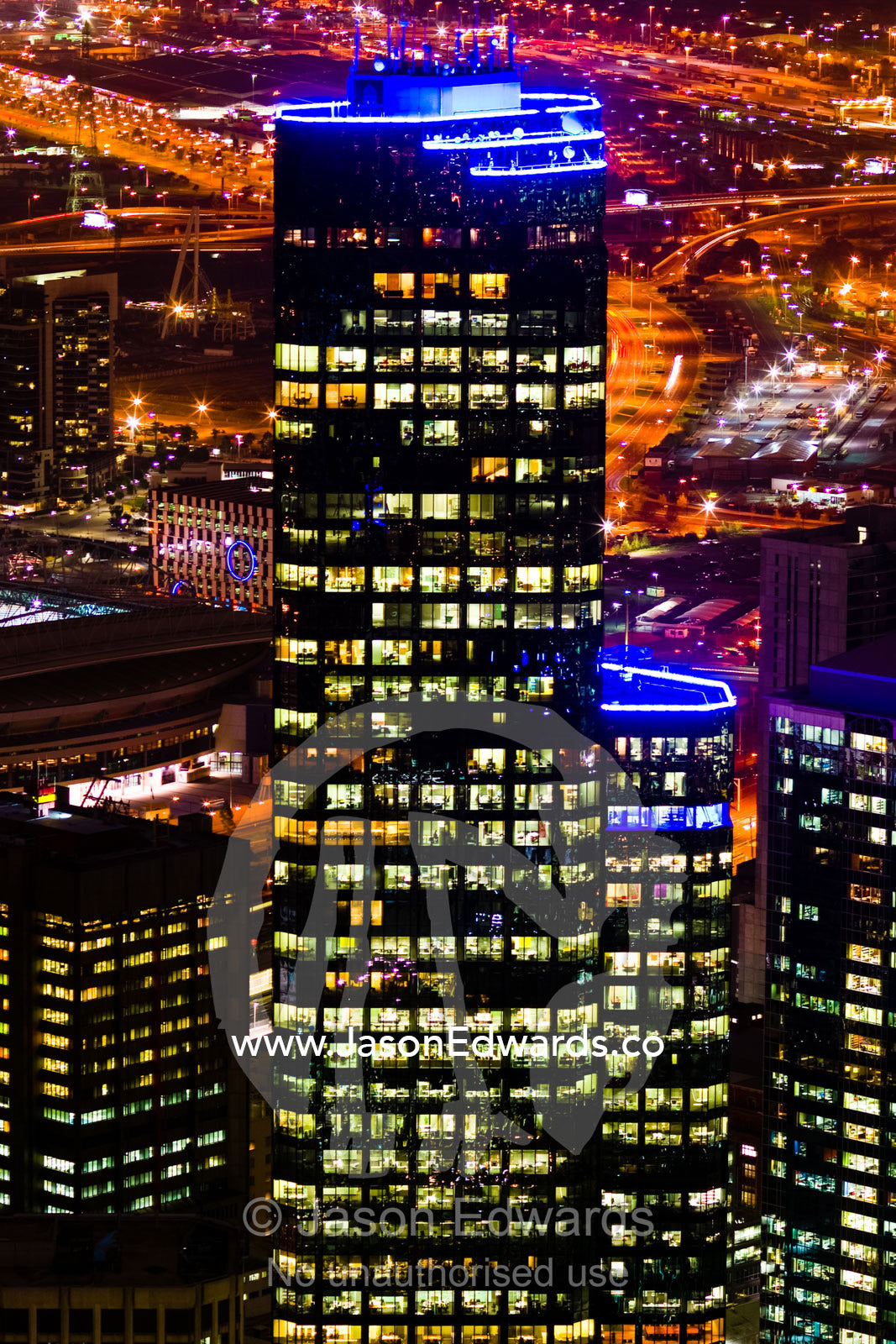 Energy hungry office towers illuminate the night sky in a major city. Melbourne, Victoria, Australia.