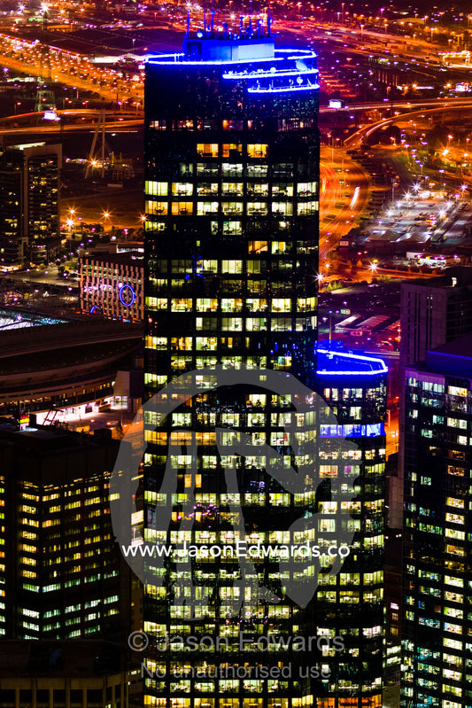 Energy hungry office towers illuminate the night sky in a major city. Melbourne, Victoria, Australia.