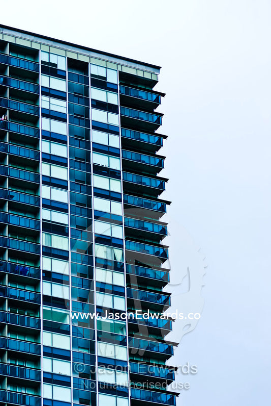 Balconies in a highrise apartment complex look into an empty skyline. Melbourne, Victoria, Australia.