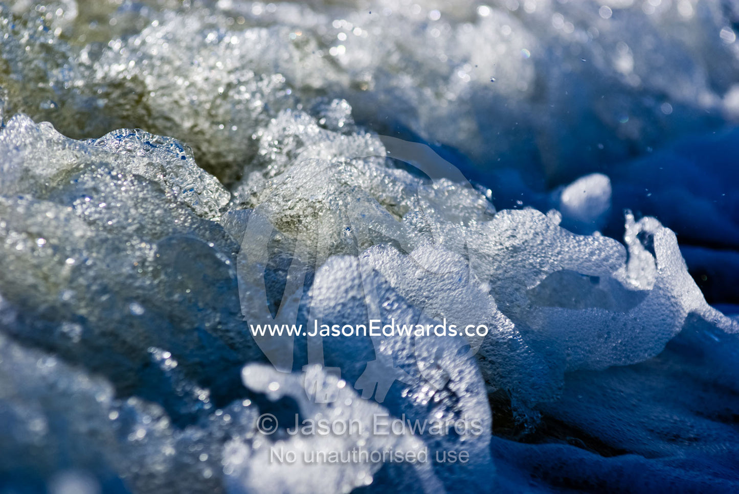 Bubbles and foam erupt in the wake of a boat. Lakes Entrance, Victoria, Australia.