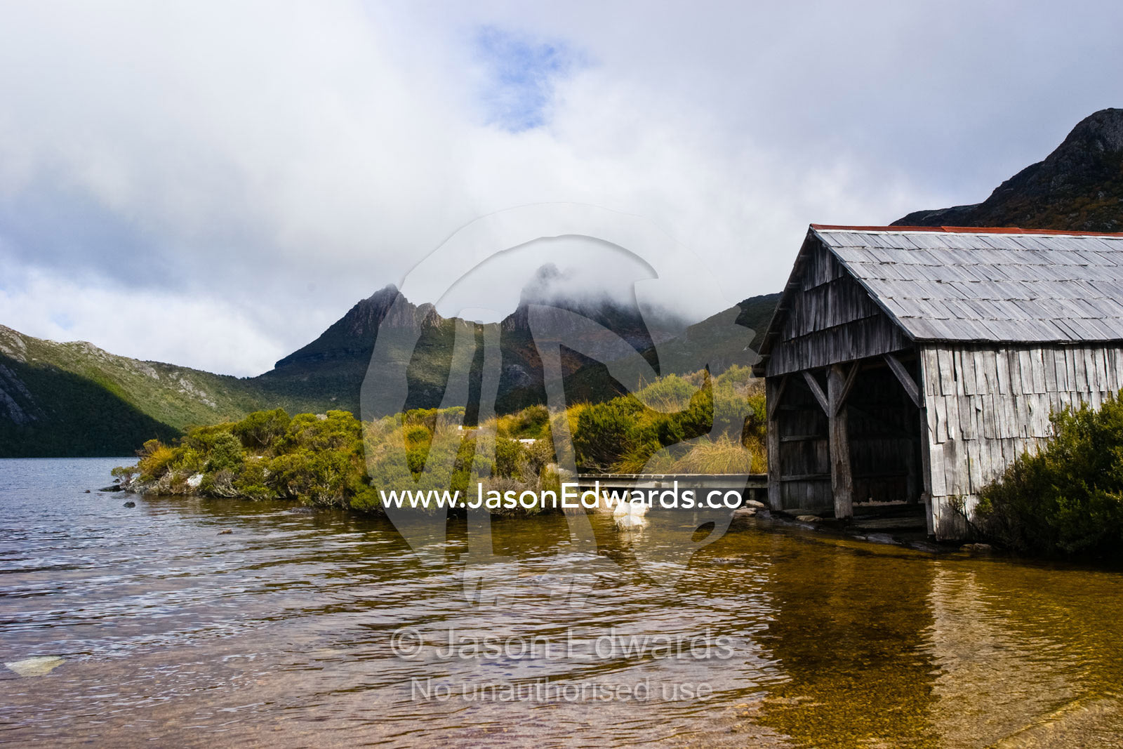 An antique timber boathouse on the shores of Dove Lake. Cradle Mountain Lake St Clair National Park, Tasmania, Australia.