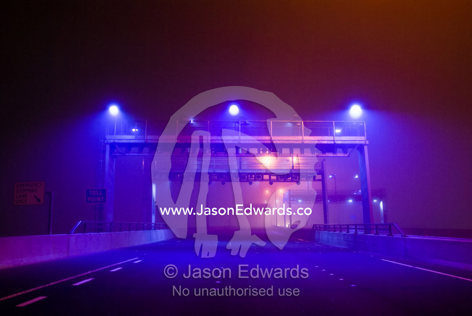 A gantry for detecting motor vehicles on a bridge emerges from the fog Bolte Bridge, Melbourne, Victoria, Australia.