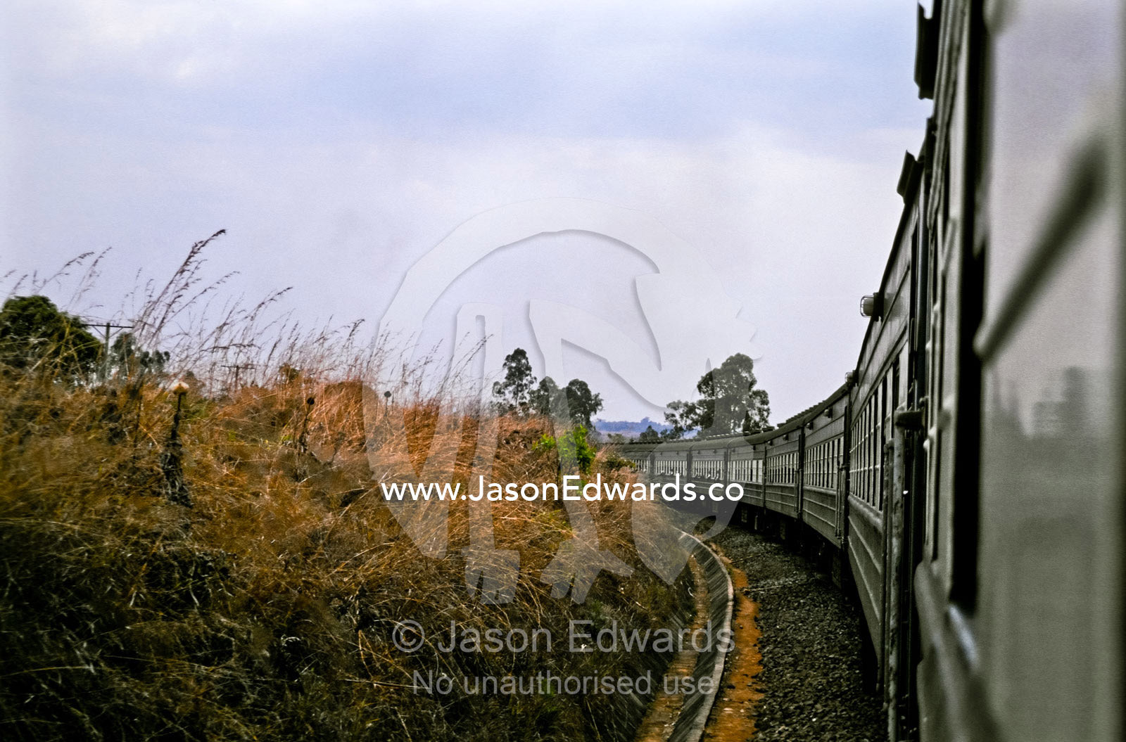 Carriages from the famous Blue Train curve around a bend in the track. Southern Tanzania.