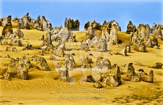 Ancient limestone pillars known as the Pinnacles rise from the desert. Nambung National Park, Western Australia.