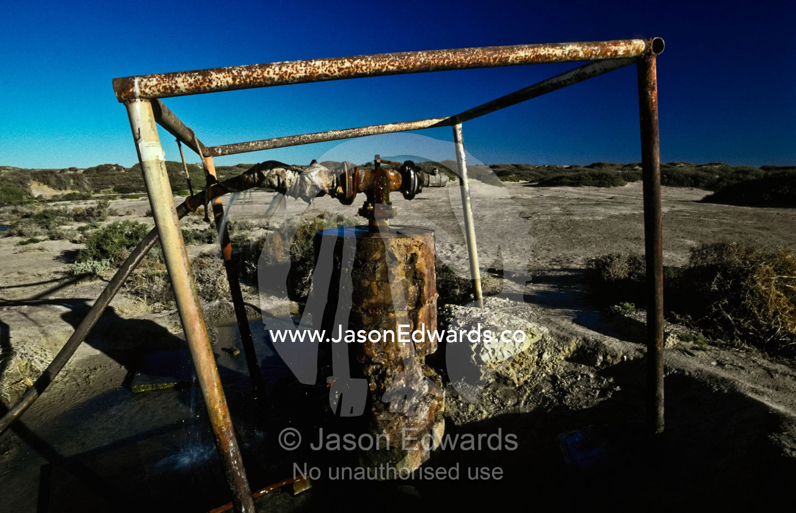 A rusting desert well head caps the water flow into Montecollina Bore. Montecollina Bore, Strzelecki Track, Strzelecki Regional Reserve, South Australia, Australia.