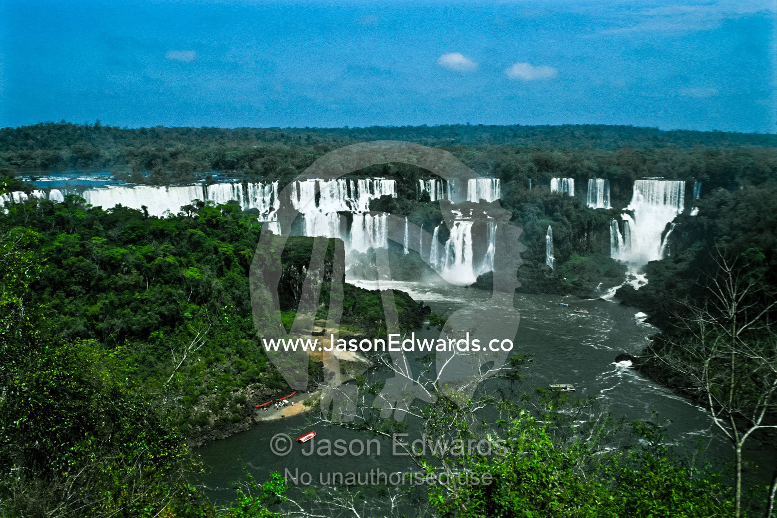 The Iguazo River plummets through steaming subtropical rainforest. Iguazo Falls, Iguazu National Park, Argentina.