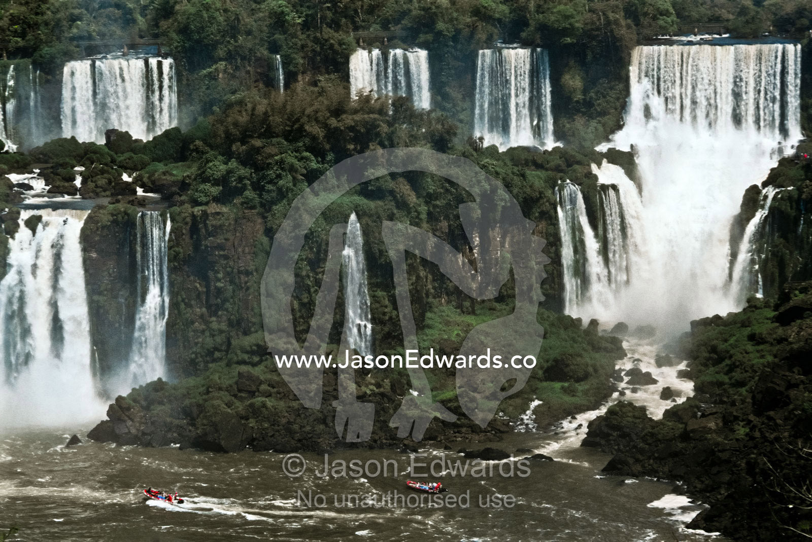 The Iguazo River plummets through steaming subtropical rainforest. Iguazo Falls, Iguazu National Park, Argentina.
