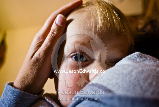 A single tear falls from the deep blue eye of a distressed baby. North Carlton, Victoria, Australia.