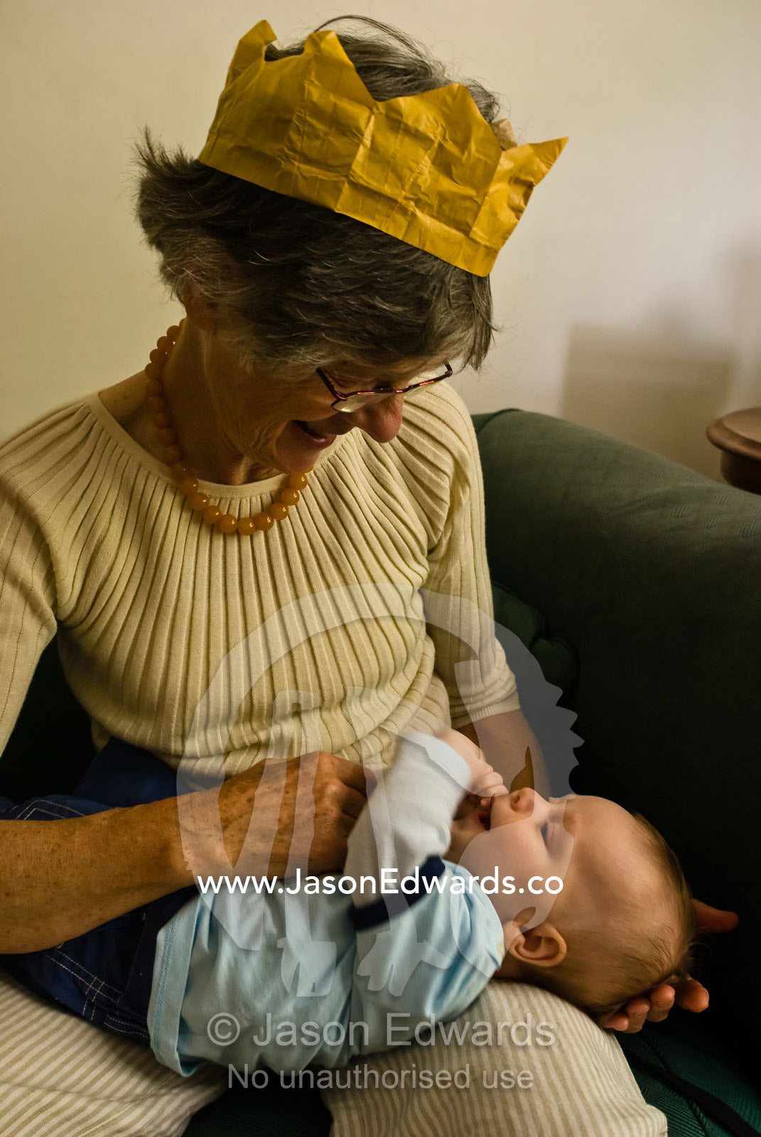 A baby looks adoringly up at his grandmother on Christmas Day lunch. East Malvern, Victoria, Australia.