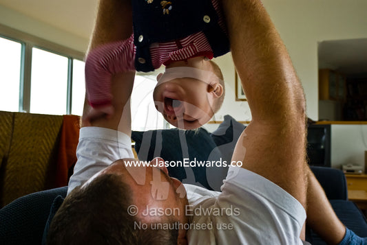 The toothless laughter of a baby being held upside down by his father. Metung, Gippsland Lakes, Victoria, Australia.