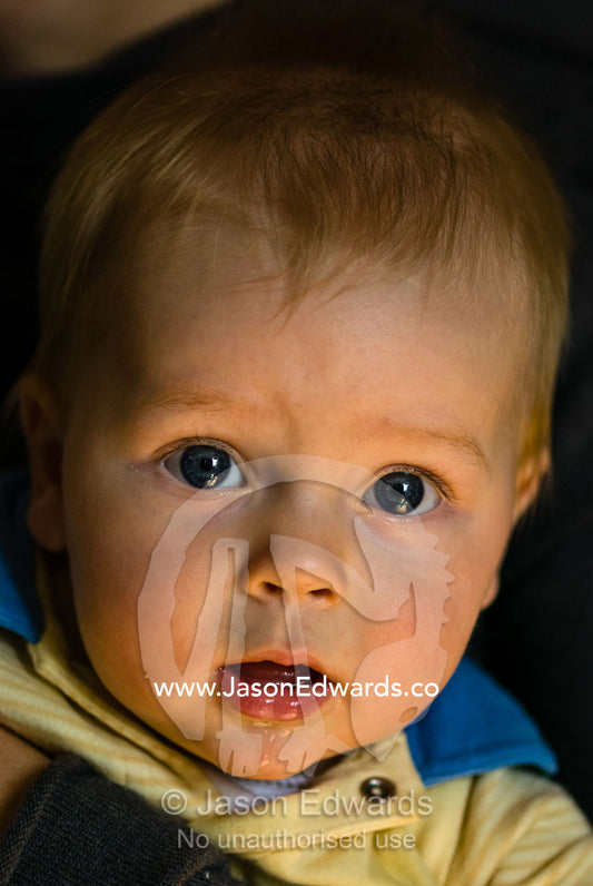 An inquisitive baby boy with an angelic expression and bright eyes. Collingwood, Victoria, Australia.