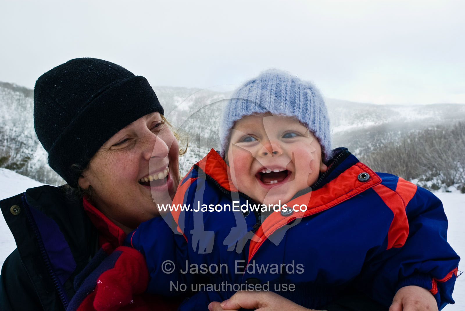 A mother and son enjoying a winter day in an alpine ski resort. Falls Creek, Alpine National Park, Victoria, Australia.