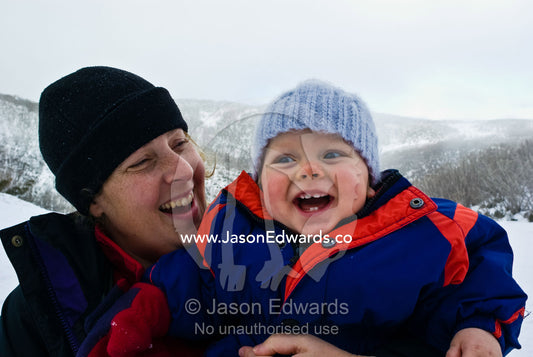 A mother and son enjoying a winter day in an alpine ski resort. Falls Creek, Alpine National Park, Victoria, Australia.