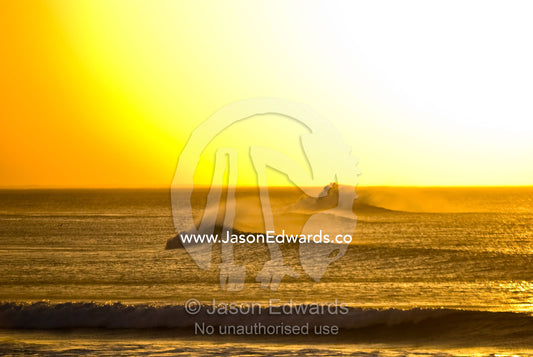 Clean lines of swell from Bass Strait roll over a reef at dawn. Point Danger, Torquay, Surf Coast, Victoria, Australia.