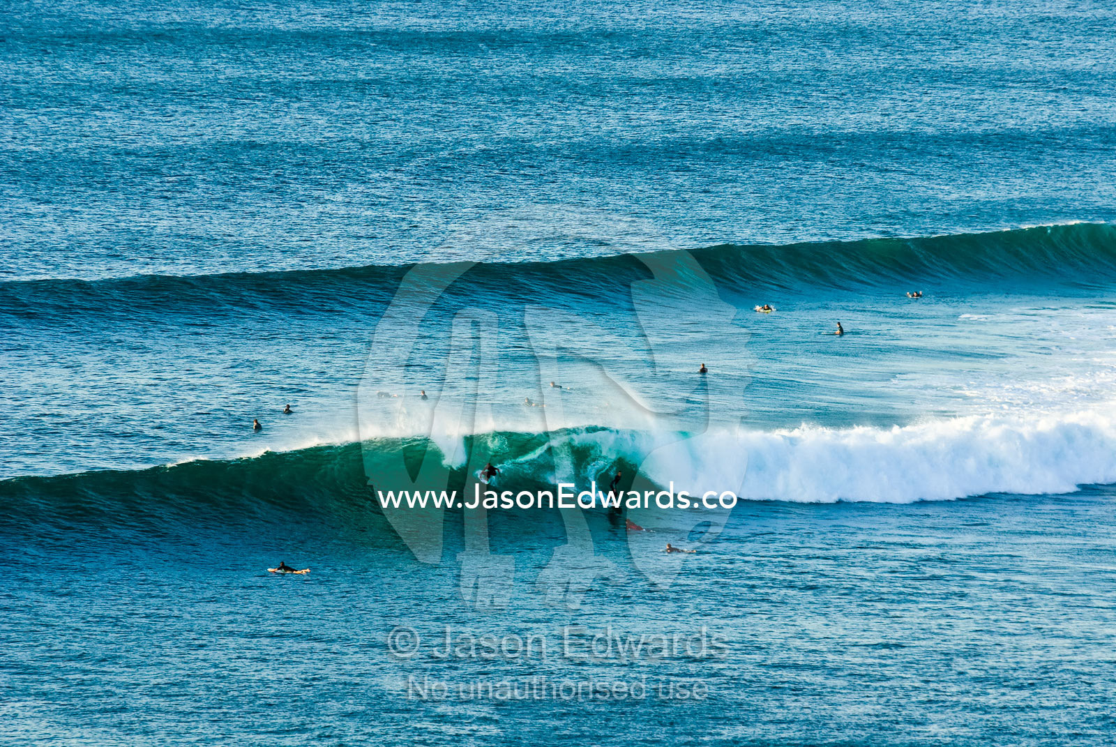 Surfers vie for position in the lineup as surf peels off Rincon Point. Bells Beach Surfing Recreation Reserve, Surf Coast, Victoria, Australia.