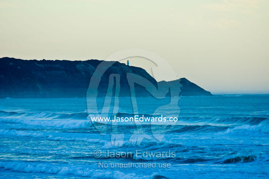 Cape Schanck Lighthouse over Bass Strait's stormy seas at pre dawn. Gunnamatta Beach, Point Nepean National Park, Victoria, Australia.