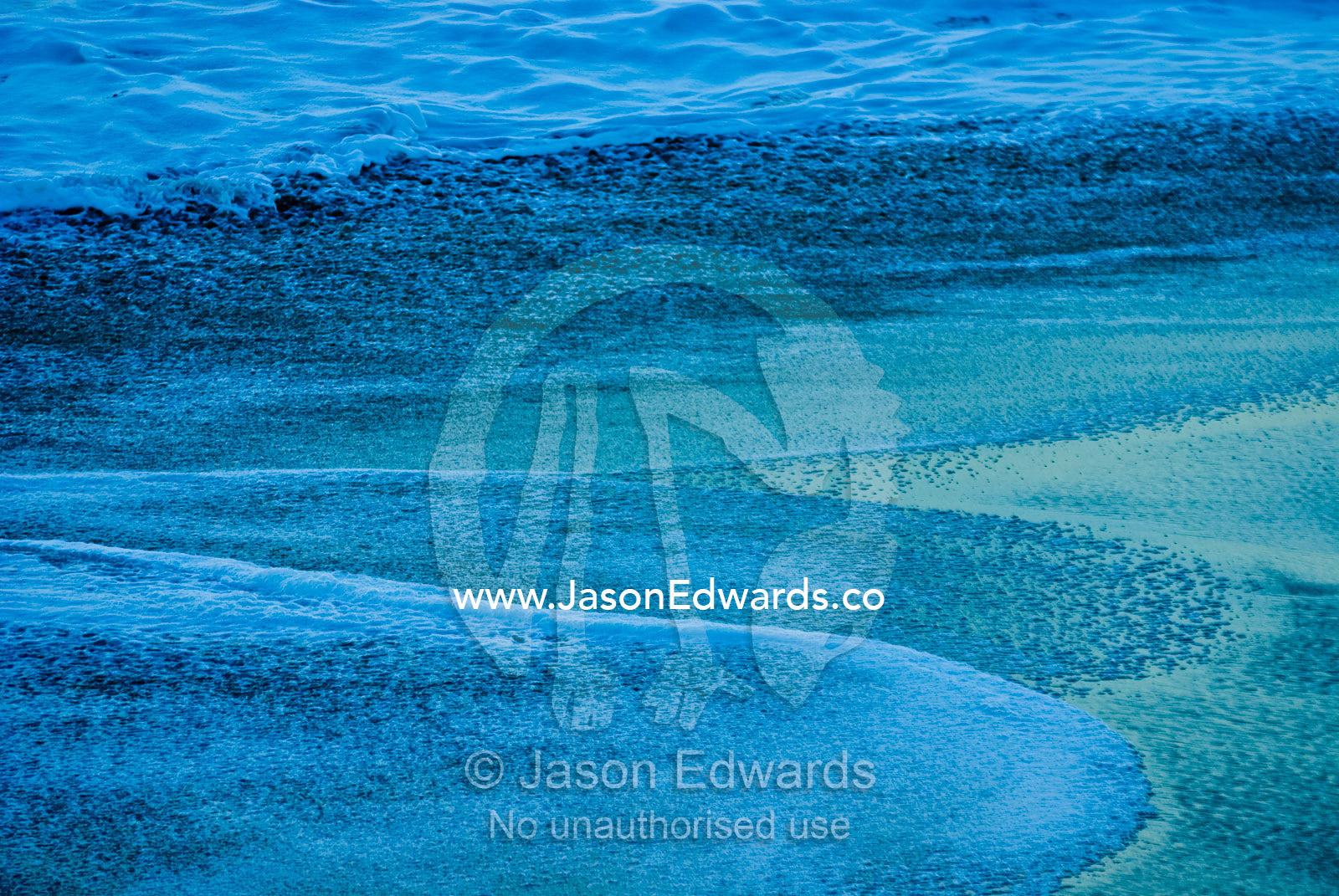 Bass Strait seas flow up onto an empty beach in the pre-dawn light. Gunnamatta Beach, Point Nepean National Park, Victoria, Australia.