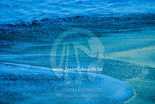 Bass Strait seas flow up onto an empty beach in the pre-dawn light. Gunnamatta Beach, Point Nepean National Park, Victoria, Australia.