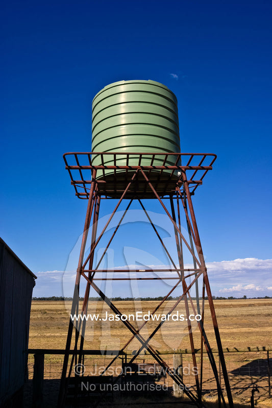 A large tank provides water for sheep on a drought-stricken farm. Mundiwa Station, Deniliquin, New South Wales, Australia.