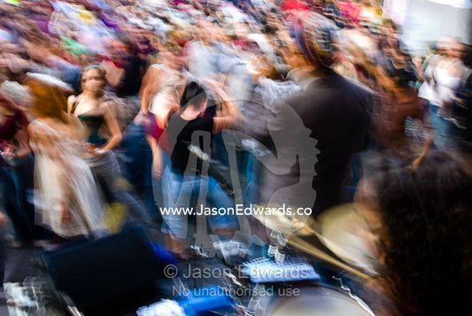 A crowd dances in a frenzy to Latin music at a free summer festival. Brunswick Festival, Brunswick, Victoria, Australia.