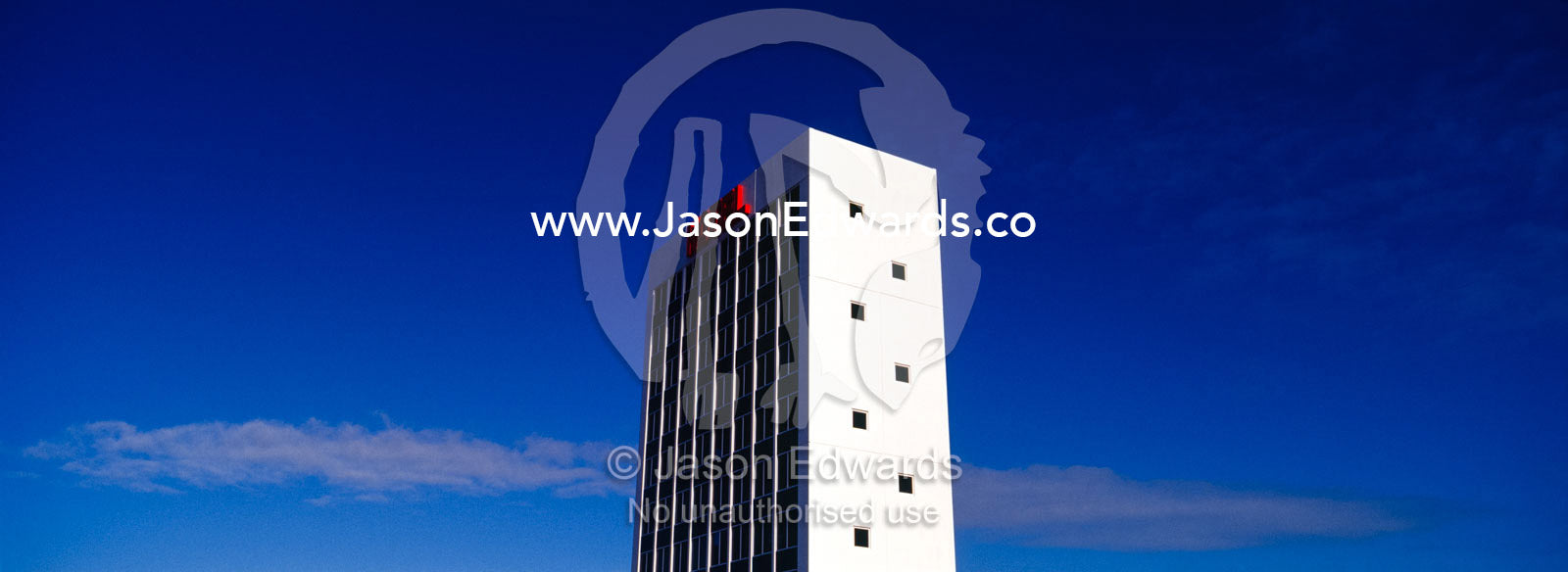A stark white hotel that is a public art display rises into the sky. Eastern and Southeastern Suburbs, Melbourne, Victoria, Australia