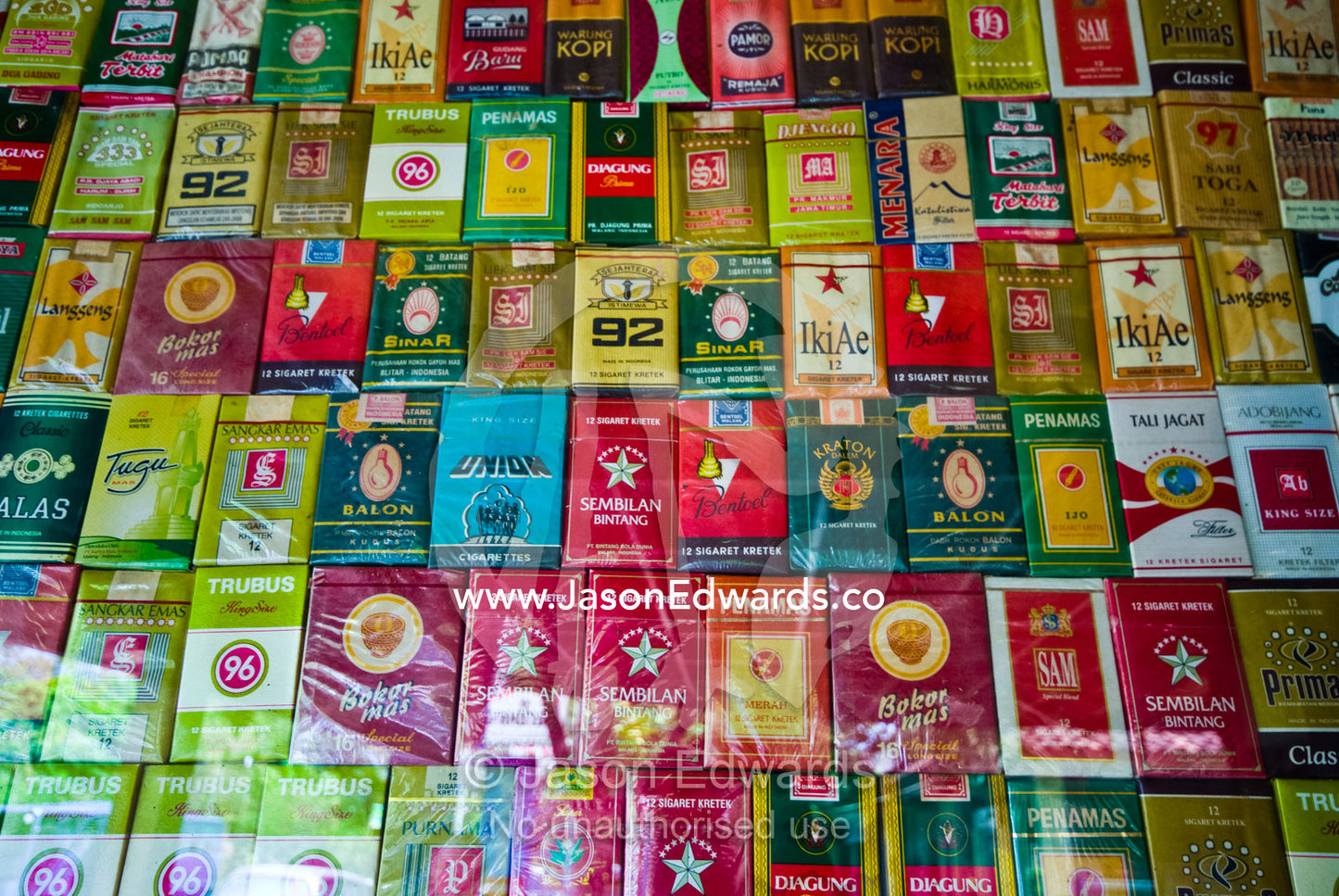 A display of colorful cigarette packets for sale in an alcohol bar. Sanur, Bali, Indonesia.