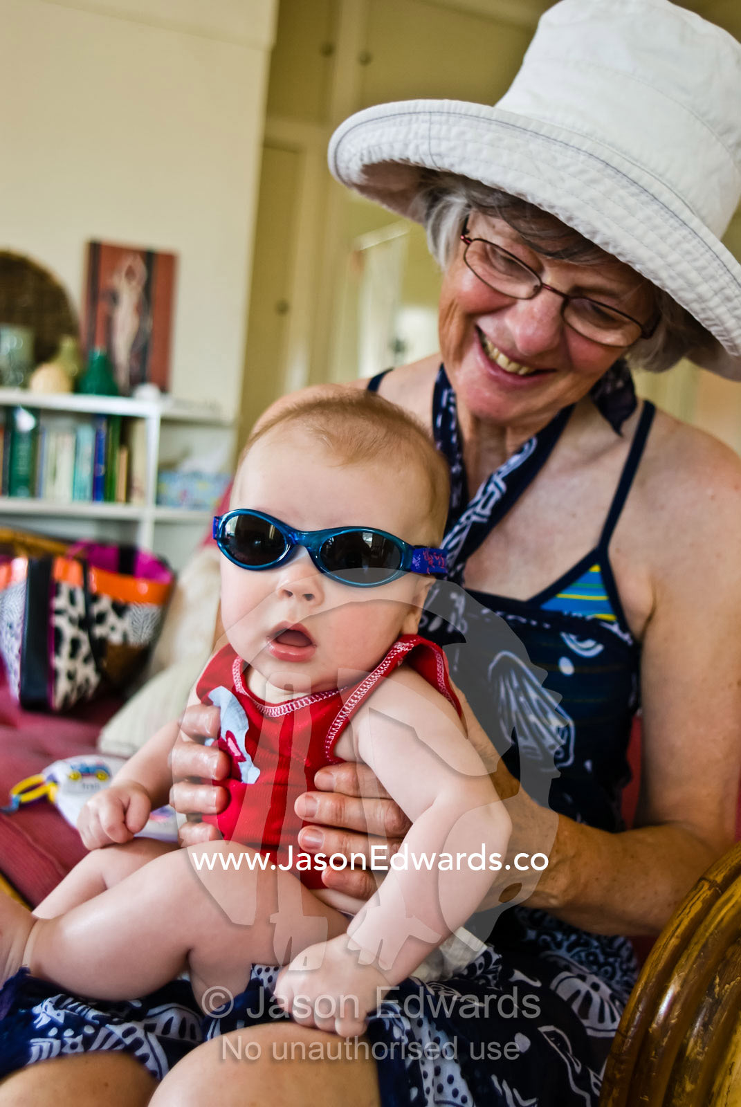 A grandmother nurses her grandson before heading off to the beach. Torquay, Victoria, Australia.