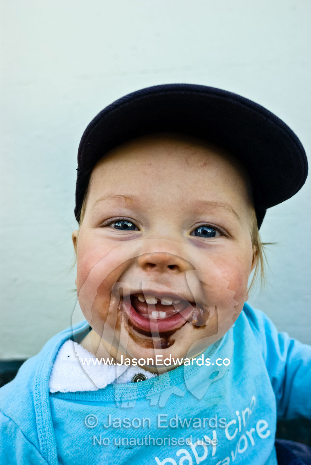 A baby on a sugar high after his first chocolate icecream experience. Rathdowne Village, Carlton North, Victoria Australia.