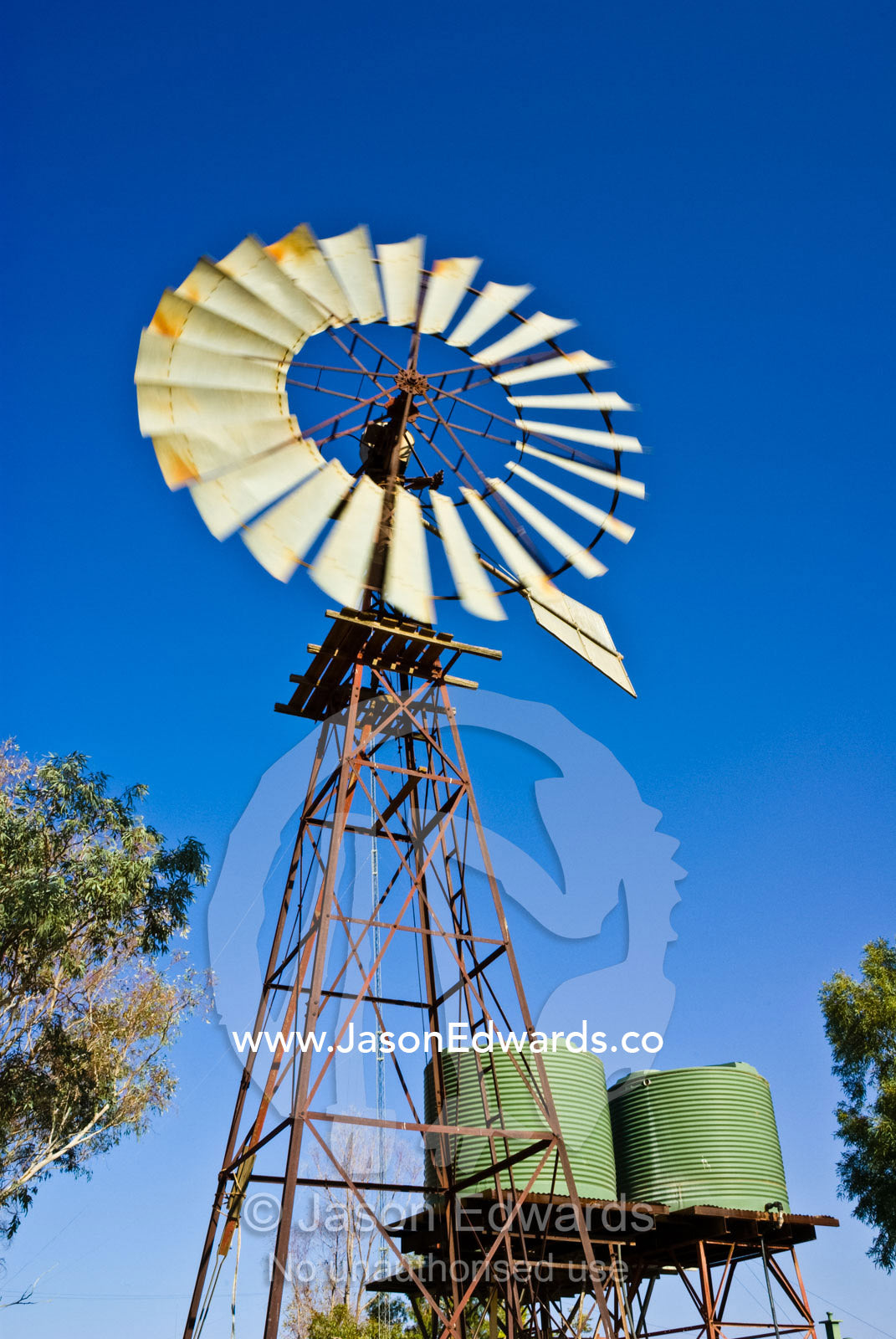 Windmills pump water reserves beneath the desert for outback stations. Sturt National Park, New South Wales, Australia.