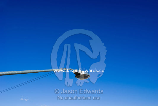A electric street light reaches into the clear blue desert sky. Broken Hill, New South Wales, Australia