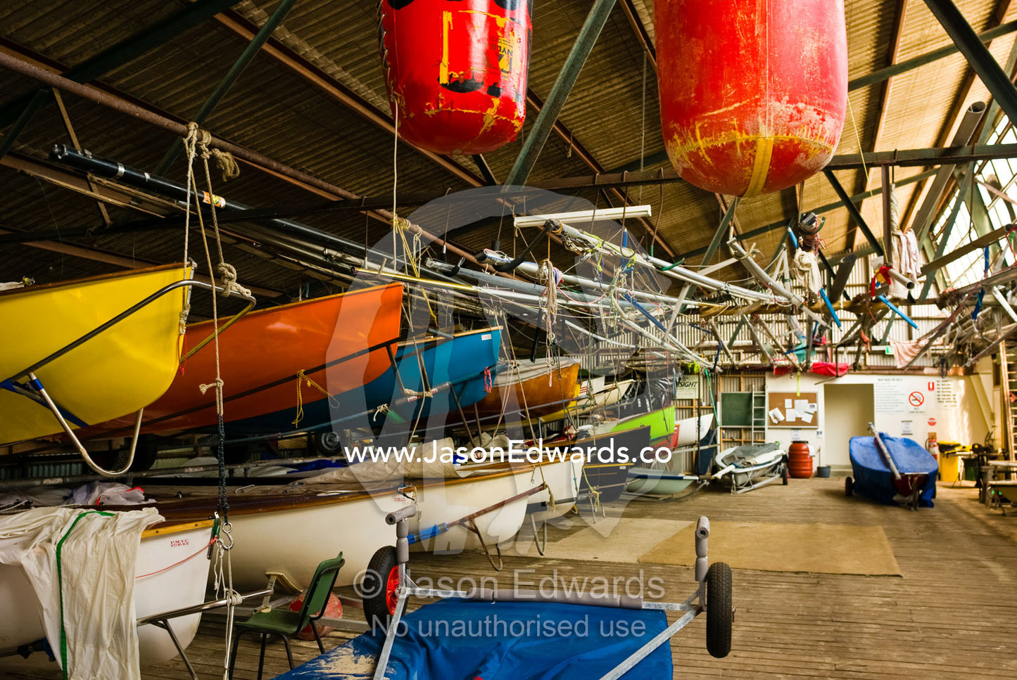 Yachts and rigging clutter a boathouse at a city beach yacht club. Port Melbourne, Victoria, Australia.