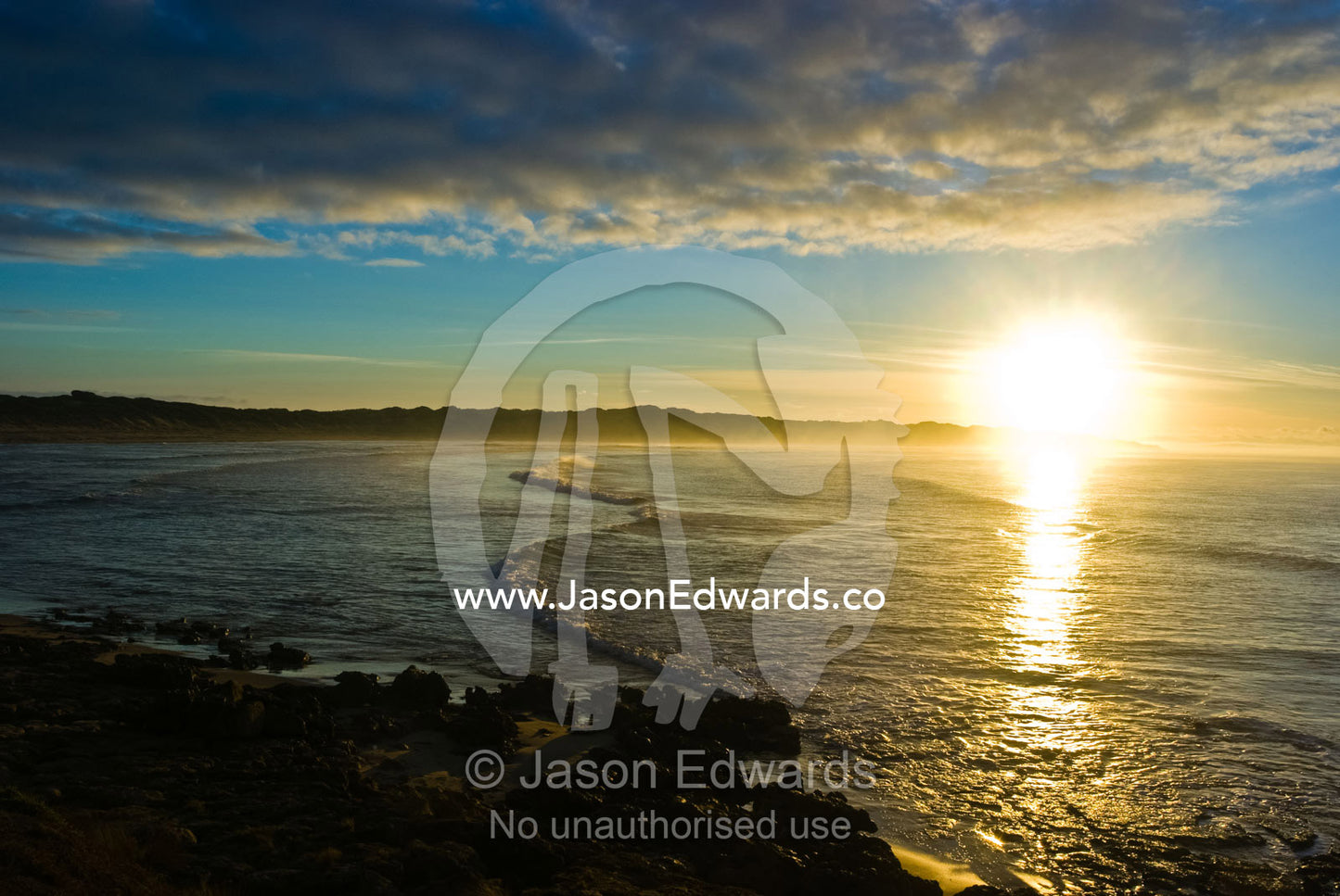 Dawn rises over a small, sheltered bay burning off the sea mist. Point Impossible, Breamlea, Victoria, Australia