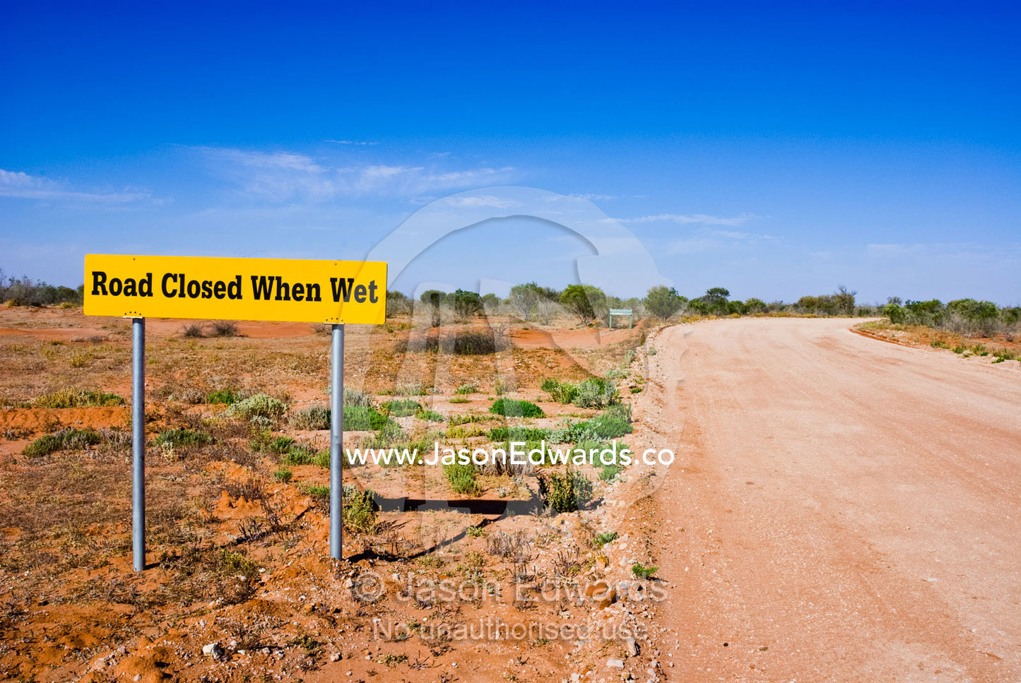 Desert track warning signs advise of when the road is open for travel. Sturt National Park, New South Wales, Australia.