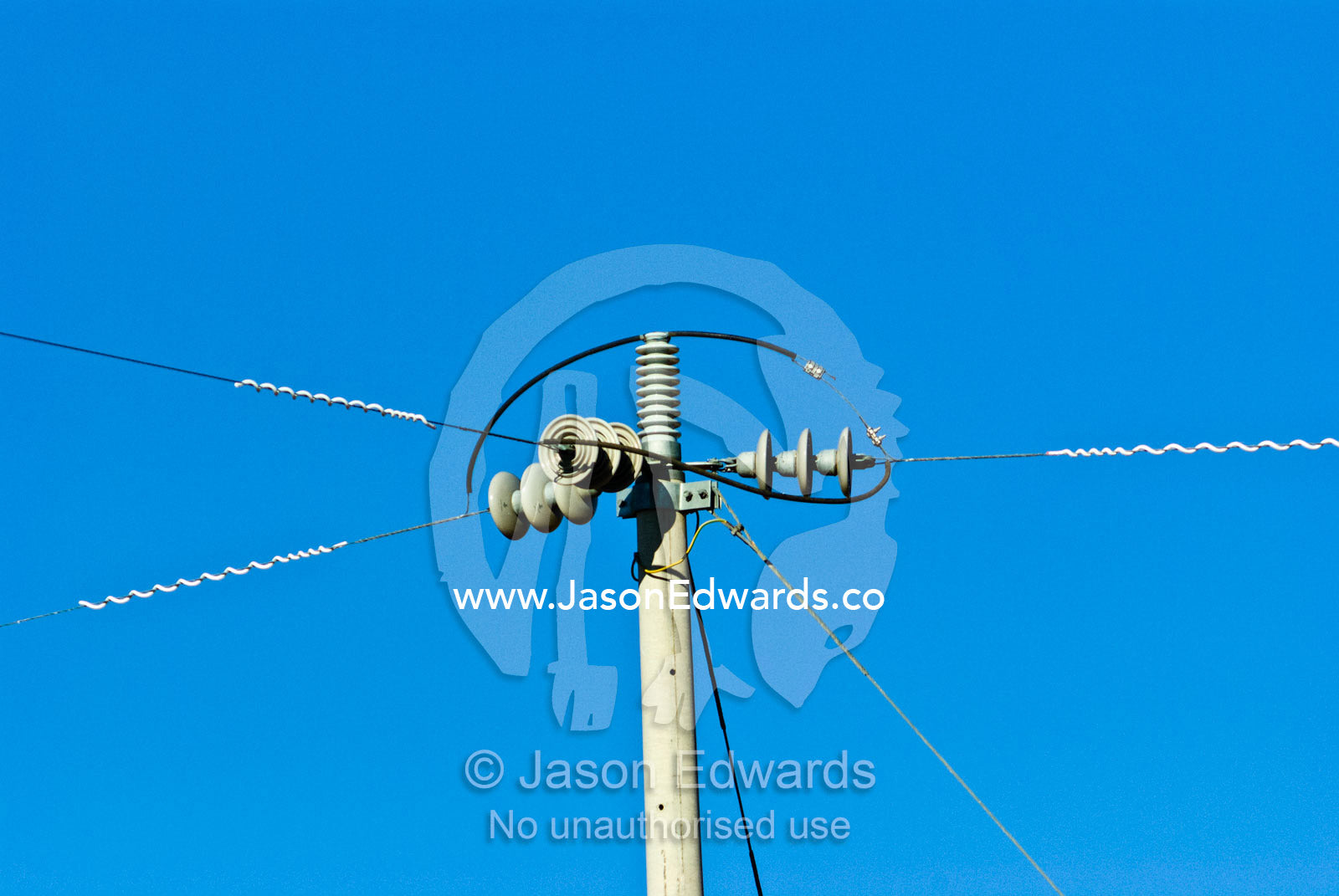 Power cables come together on an electricity pole on a cattle station. Mount Wood Station, New South Wales, Australia.