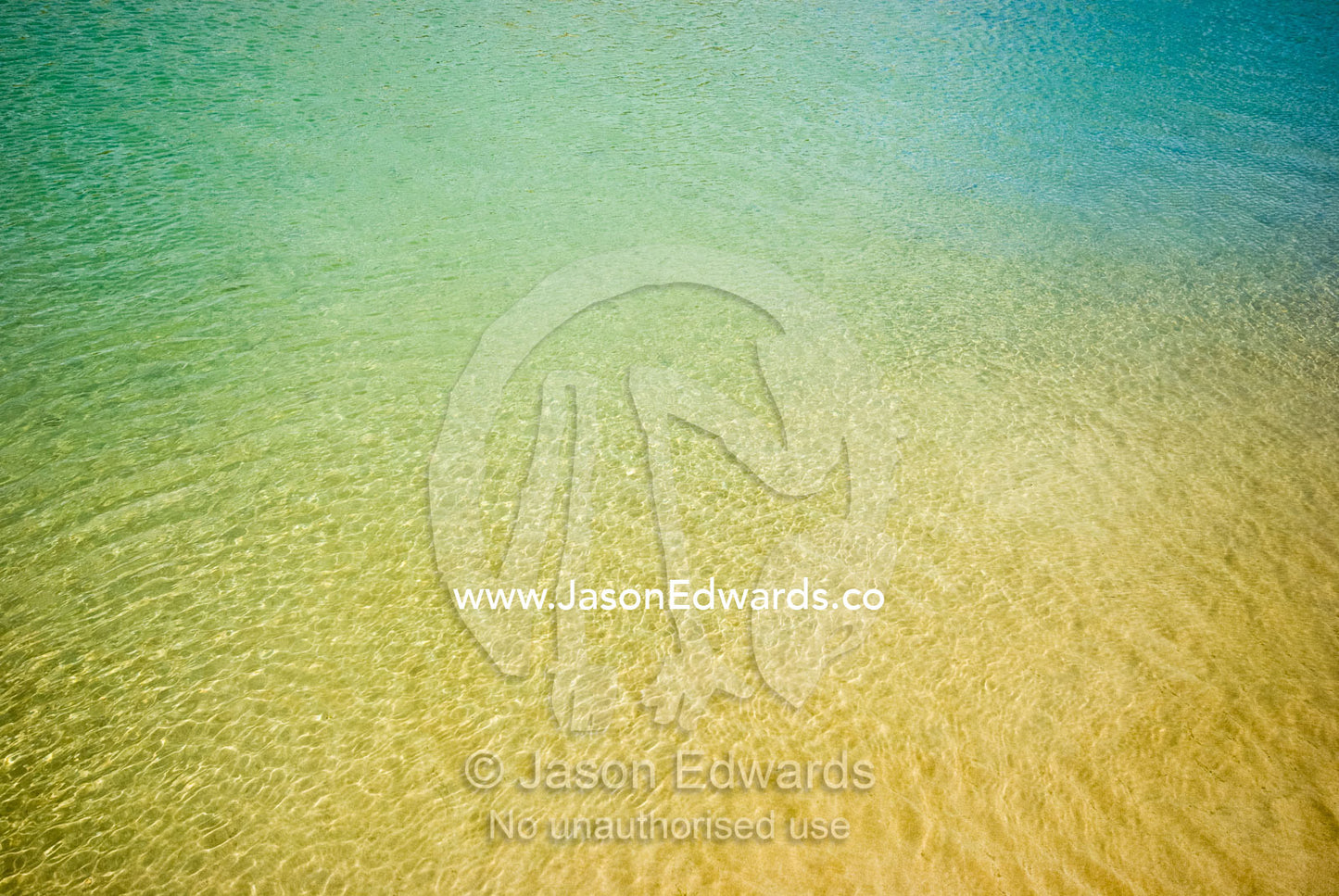 Warm, clear turquoise waters over a sandy bottom in a tidal river. Barwon River, Barwon Heads, Victoria, Australia.