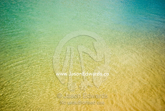 Warm, clear turquoise waters over a sandy bottom in a tidal river. Barwon River, Barwon Heads, Victoria, Australia.