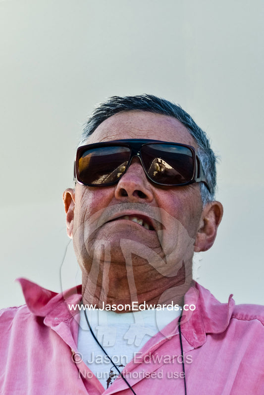 A grizzled old retired naval officer on the bow of a ship at sea. Coral Sea, Coral Sea Islands Territory, Australia.